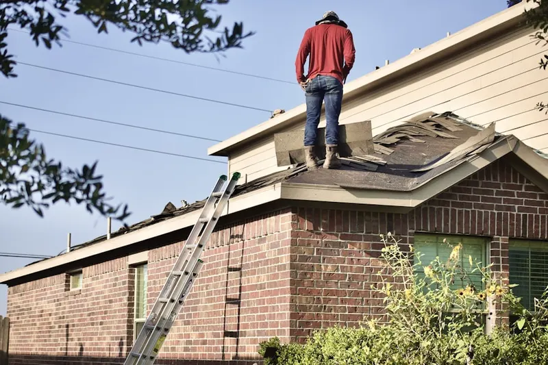 Professional roofer working on a residential roof in Mayflower Heights